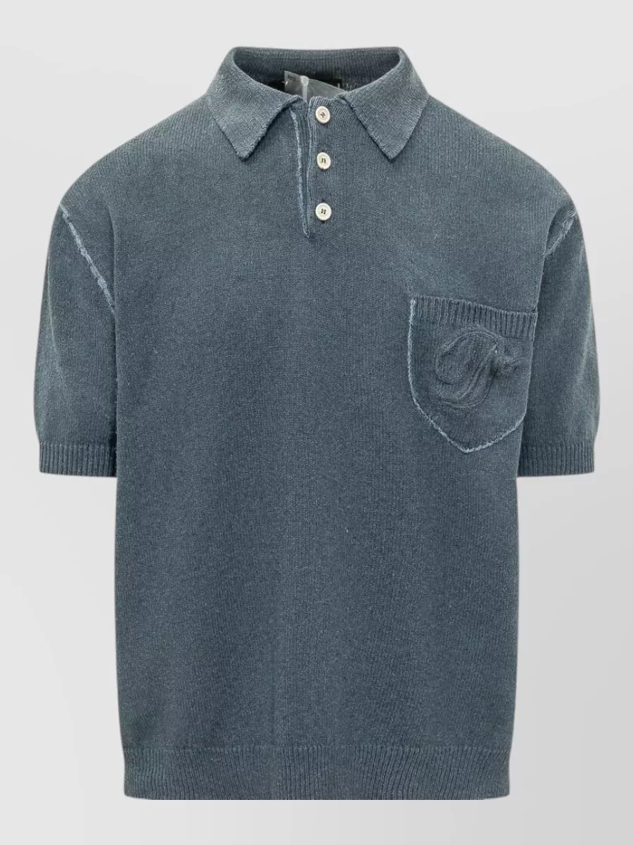 Dsquared2 Polo shirt — The slate blue knit polo hits the same Italian quiet luxury tier as the sneakers while its soft color and texture bridge the off‑white leather and indigo denim in a polished street-leaning way.