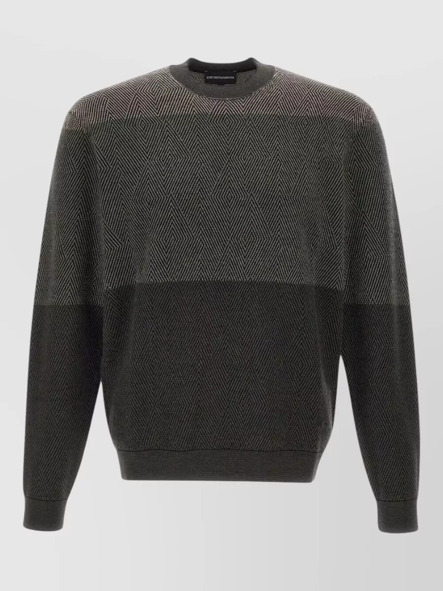 Emporio Armani Virgin wool crew neck jumper — The charcoal geometric crew knit keeps the outfit firmly in a quiet luxury lane, pairing tonally with the light grey joggers while adding subtle texture and a slightly smarter feel than a tee or logo sweat.