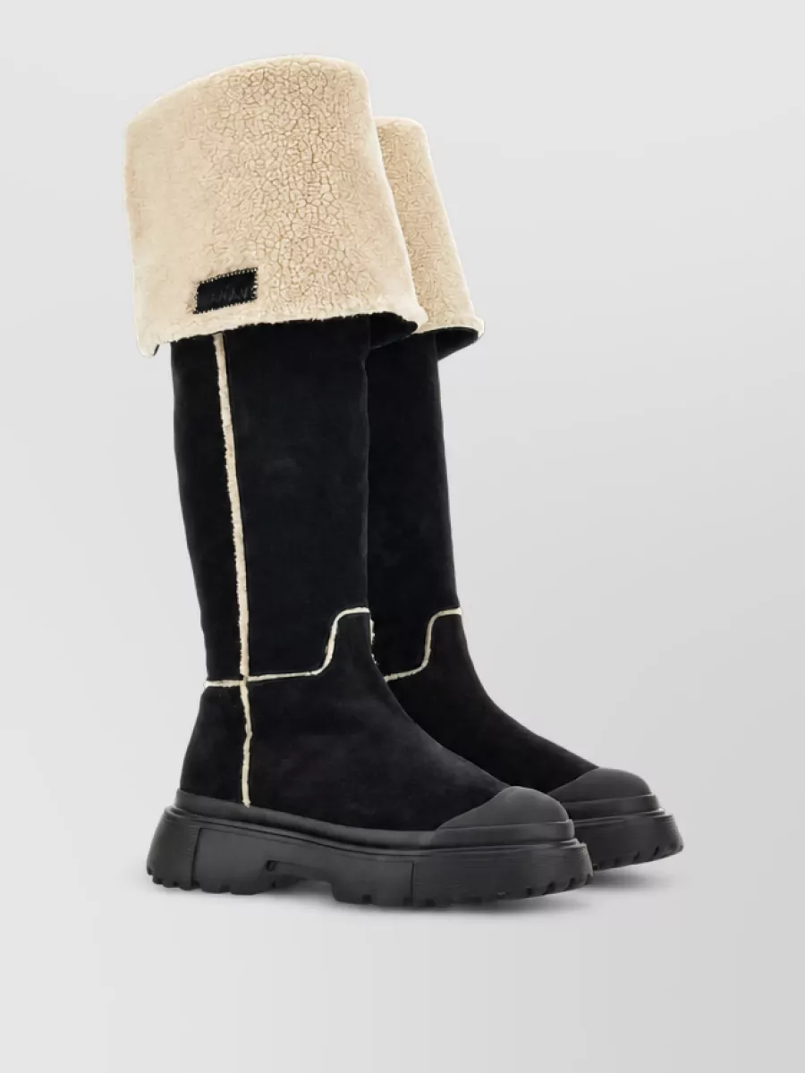 Hogan Calfskin ankle boots — The Hogan shearling knee boots in black echo the jacket’s technical warmth and add a sleek vertical line that works perfectly with the midi length and urban winter attitude.