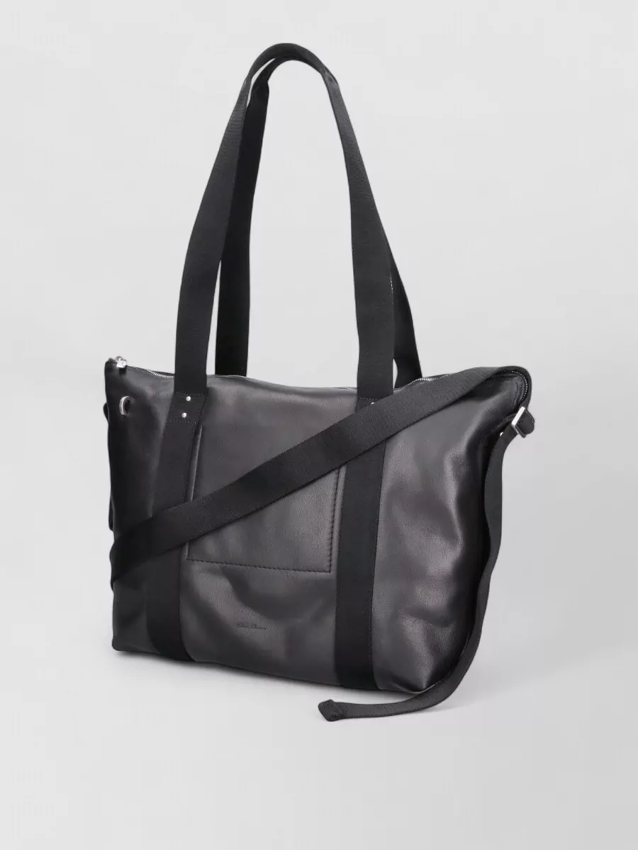 Rick Owens tote pod calf leather tote bag — The large black Rick tote matches the outfit’s moody utilitarian energy and price tier, adding practical volume without visually fighting the cardigan’s soft structure.