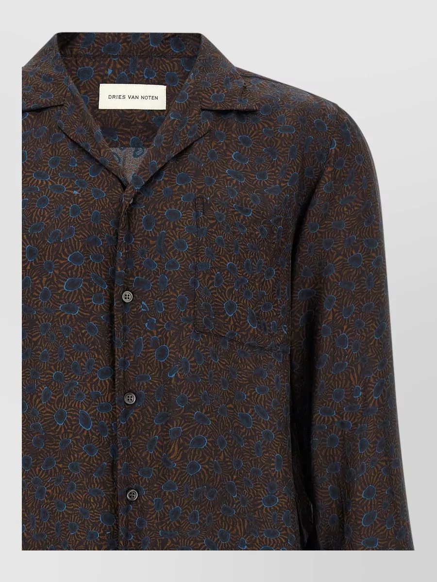 Dries Van Noten Hemp shirt — The fluid dark floral in rust, brown, and ink blue echoes the jacket’s shaggy autumnal texture without competing, and the relaxed camp collar keeps the layering casual rather than over-tailored.
