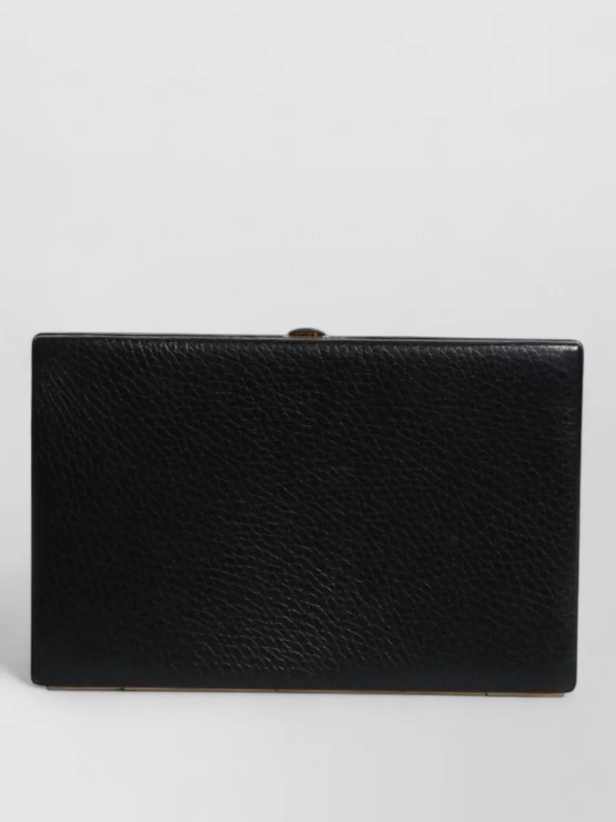 Dolce&Gabbana Mini leather clutch bag — The slim black clutch with gold hardware keeps the focus on lace textures while matching the outfit’s quiet-luxury evening polish.