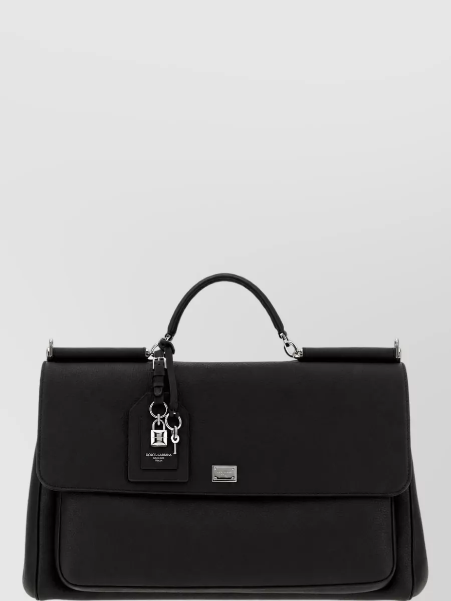 Dolce&Gabbana Leather top handle briefcase — The structured black briefcase mirrors the formality and precision of the outfit, reinforcing the boardroom-ready mood while keeping branding discreet and refined.