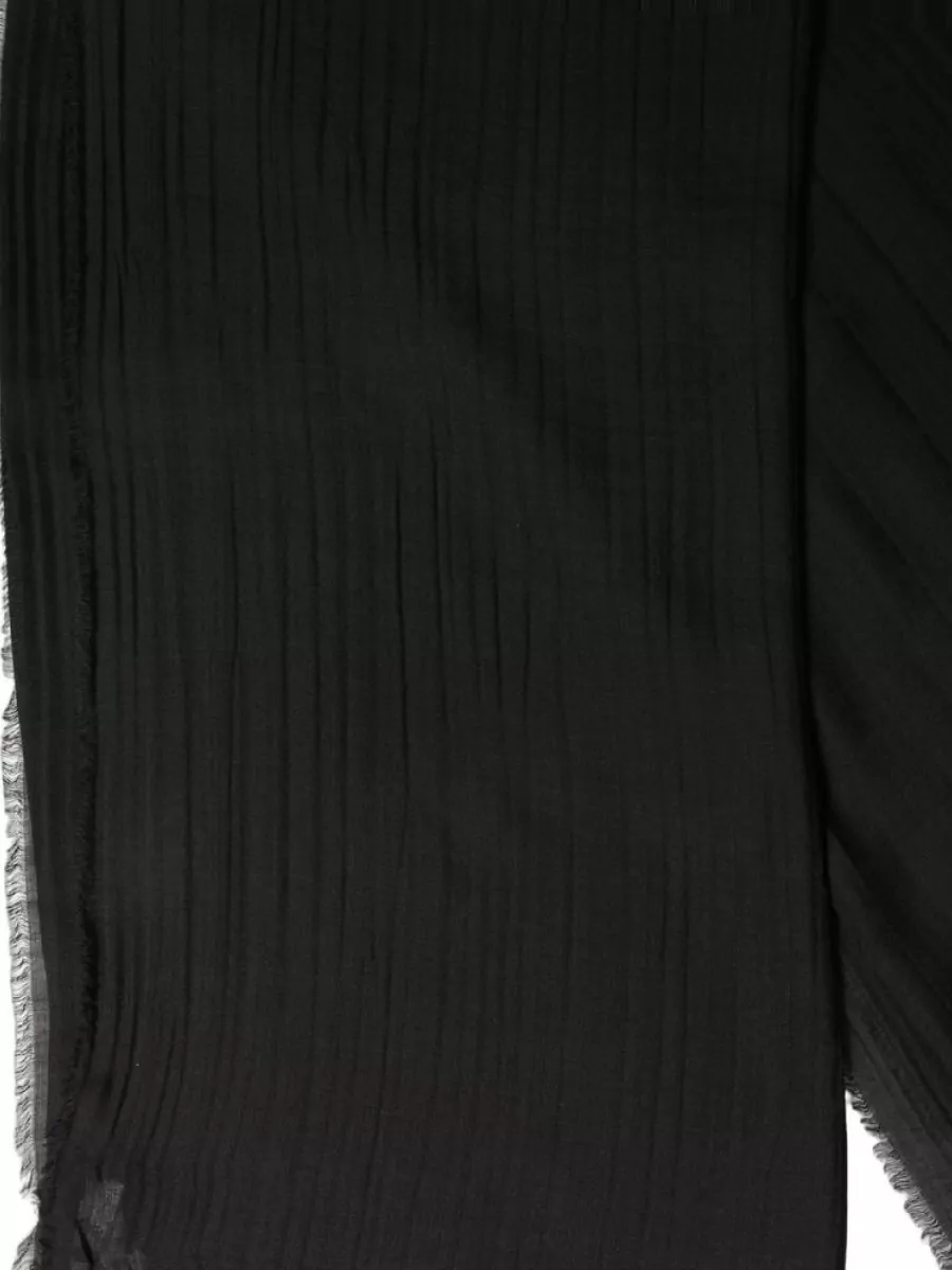Dolce&Gabbana Silk wool cashmere fringed scarf — The lightweight black scarf with soft grey fringe adds subtle texture and warmth while tying together the black bag, charcoal denim and the tee’s soft grey notes.