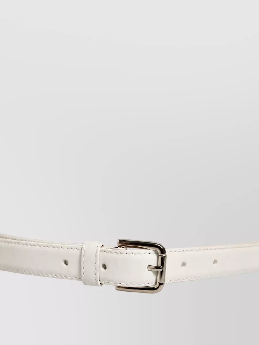 Dolce&Gabbana Leather belt — Dolce&Gabbana’s slim white belt subtly defines the waist and integrates effortlessly with the trouser’s high-rise tailoring, keeping the finish crisp and cohesive with the all-ivory ensemble.