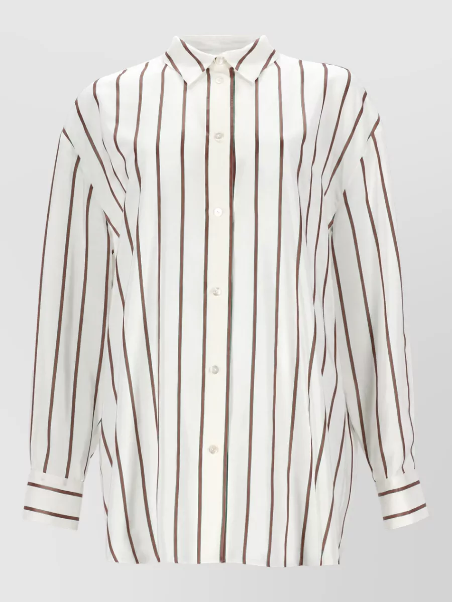 Gucci Silk shirt — The ivory and chocolate striped Gucci longline shirt reinforces the jean’s 70s mood, keeps the palette soft and warm, and its relaxed length balances the high-rise wide leg in a polished, minimalist way.
