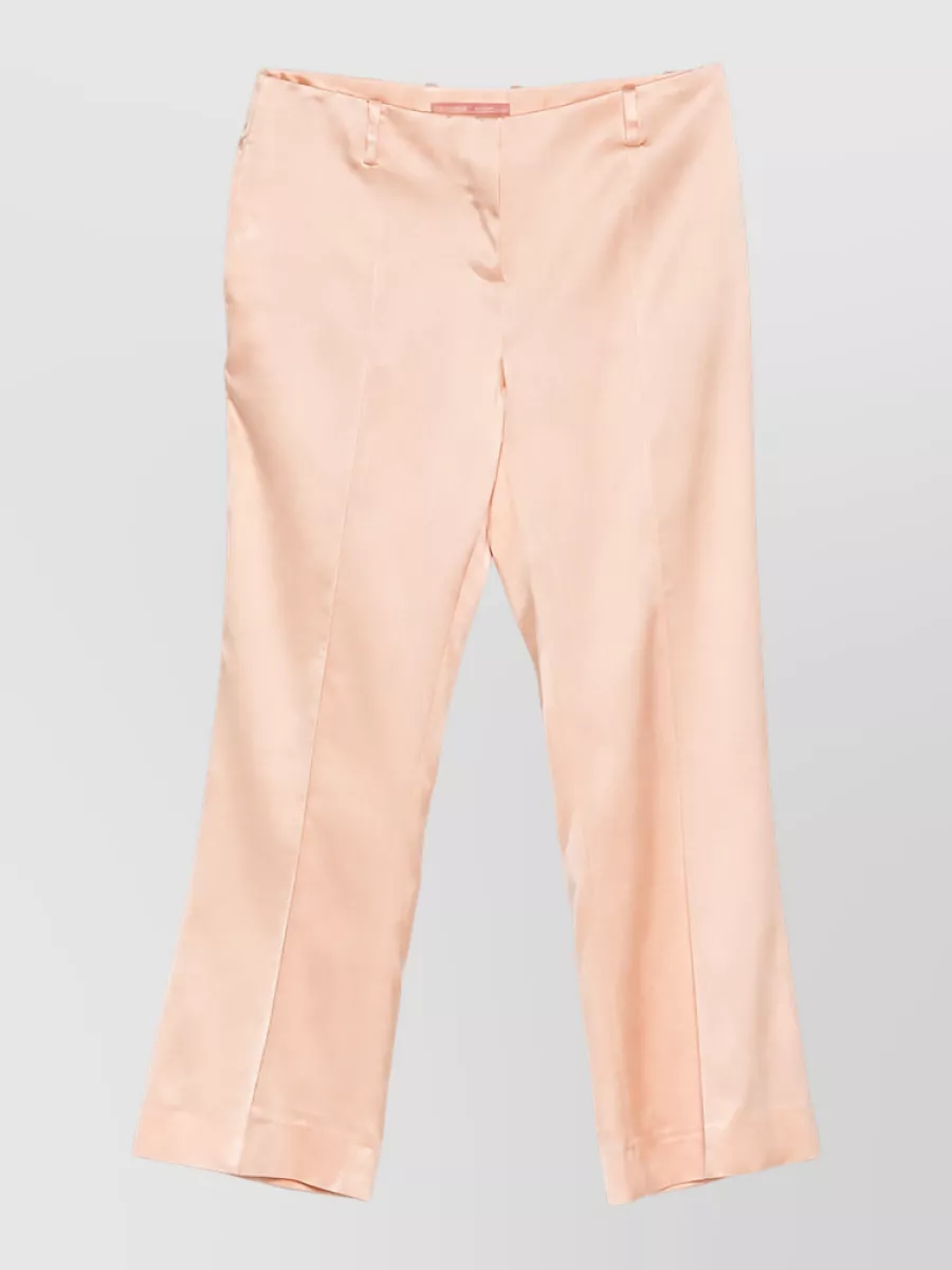 Ermanno Scervino Flared trousers — The blush peach satin flared trouser keeps the outfit in the romantic, quiet luxury space while softening the coral jacket with a long, fluid line that still reads polished for daytime events.