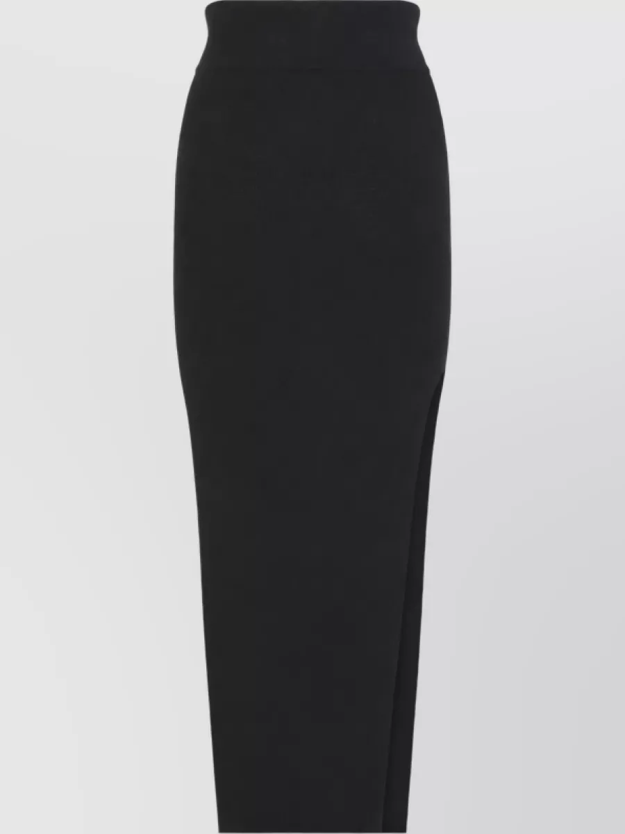 Rick Owens Ribbed high-rise wool midi skirt — The black ribbed high-waisted maxi with slit keeps the column in the same knit language as the top, extending the minimalist Rick line while adding just enough movement through the leg.