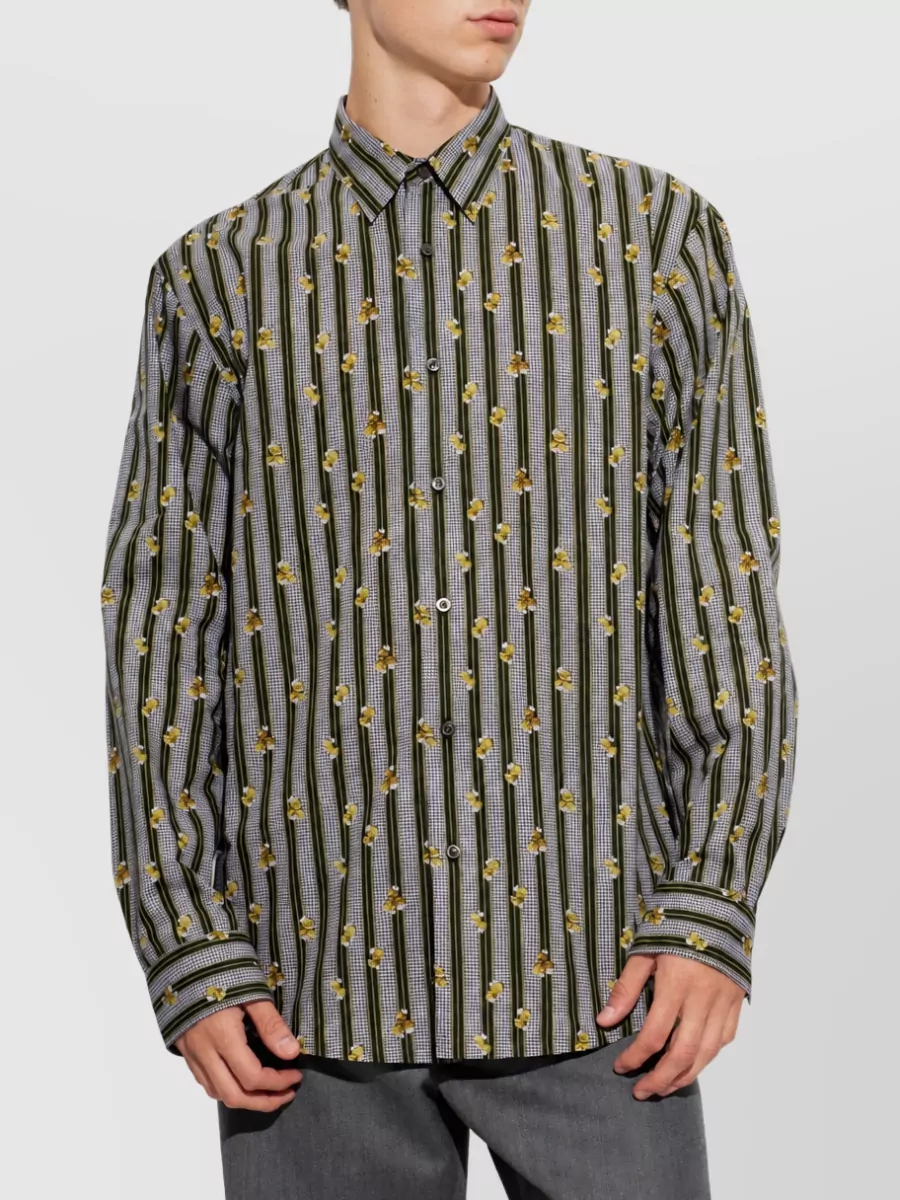 Dries Van Noten Cotton casual shirt — C mirrors the trouser’s navy and soft yellow story with its black ground, golden florals and stripe, creating a coherent romantic-tailored print-on-print that still feels polished with the wide-leg silhouette.