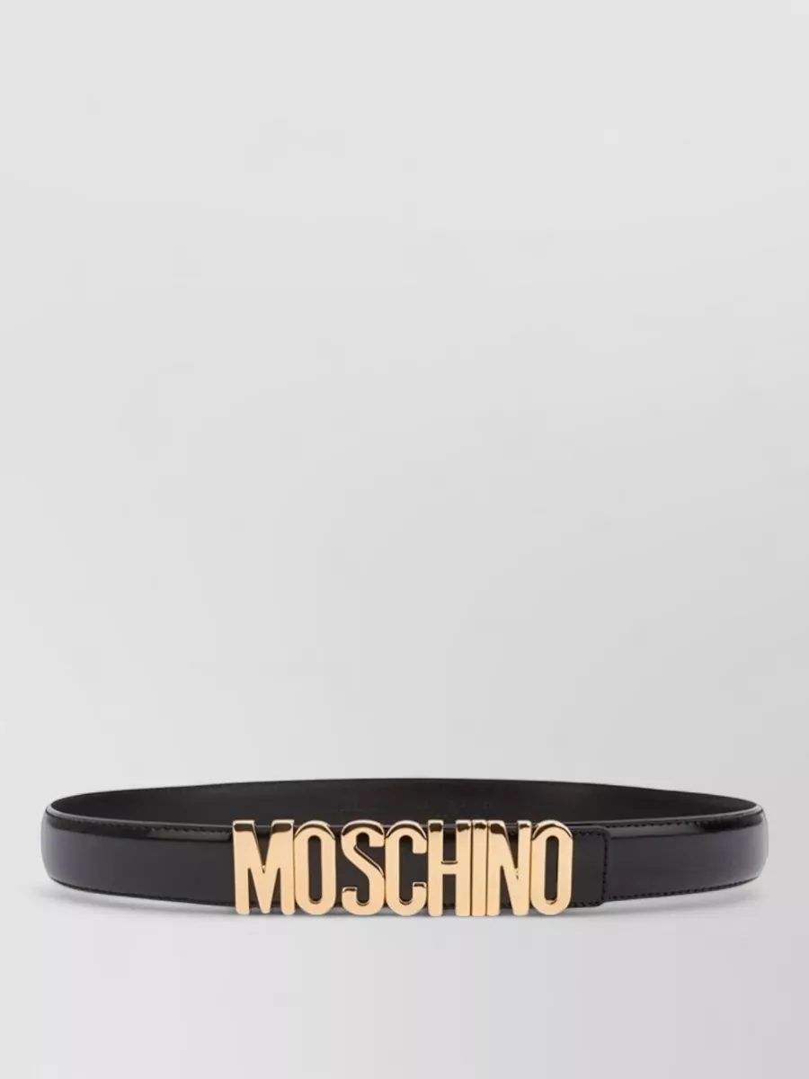 Moschino Leather logo belt — The slim black logo belt can cinch the tee slightly at the waist, adding definition and an extra Moschino hit without fighting the already strong graphics.
