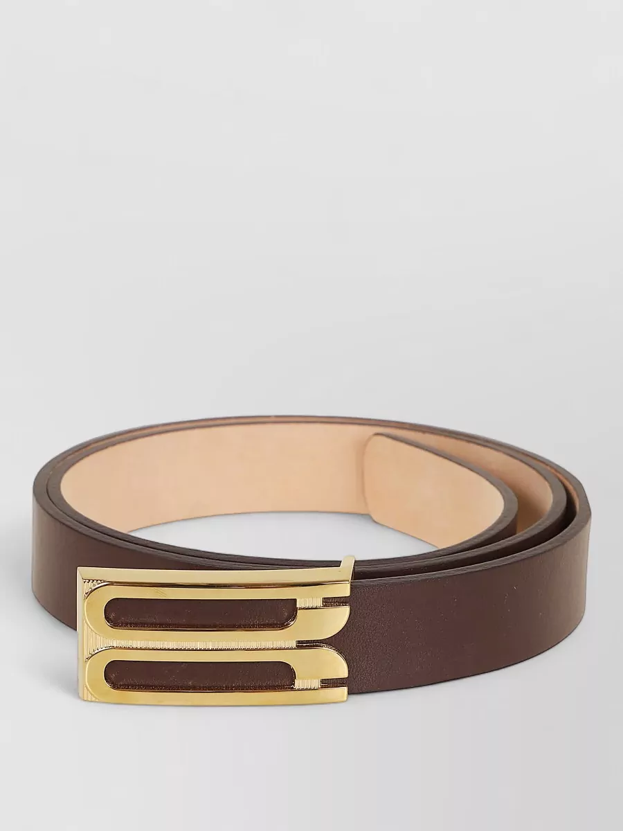 Victoria Beckham Leather belt — The slim chocolate Victoria Beckham belt quietly defines the waist over or through the corduroy, refining the tailored line without breaking the monochrome effect.