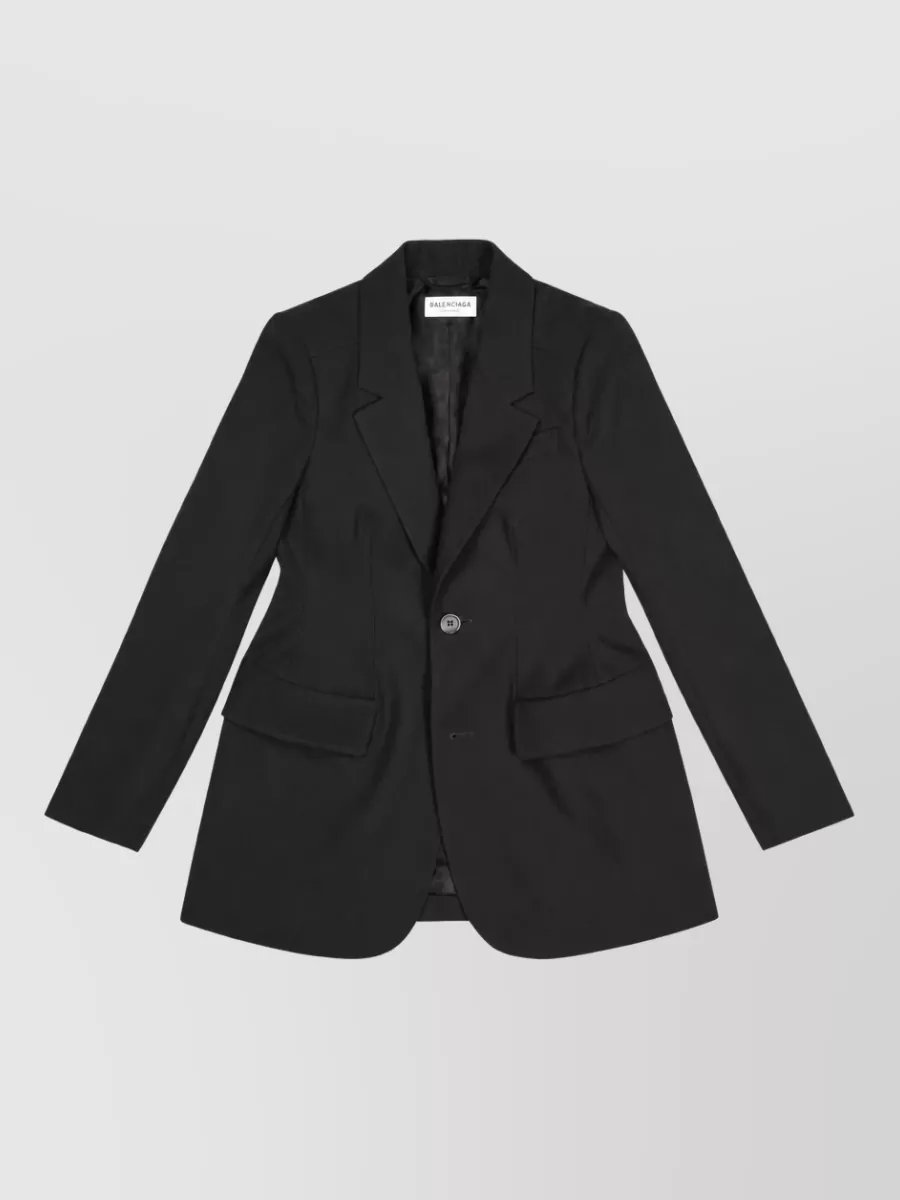 Balenciaga Virgin wool hourglass suit jacket — The sharply tailored longline Balenciaga blazer in black mirrors the pant-skirt’s architectural minimalism and formality, keeping a strict column while subtly defining the waist for a pure, quiet-luxury suit effect.
