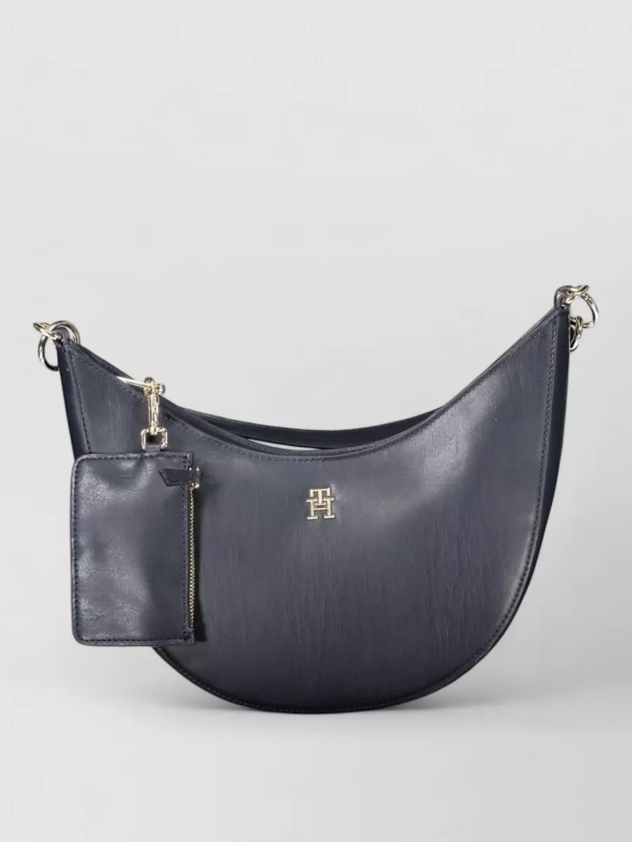 Tommy Hilfiger Polyethylene shoulder bag — The navy crescent shoulder bag feels sporty-preppy yet polished, staying within the blue palette and offering an easy hands-free proportion that suits relaxed joggers and sneakers.