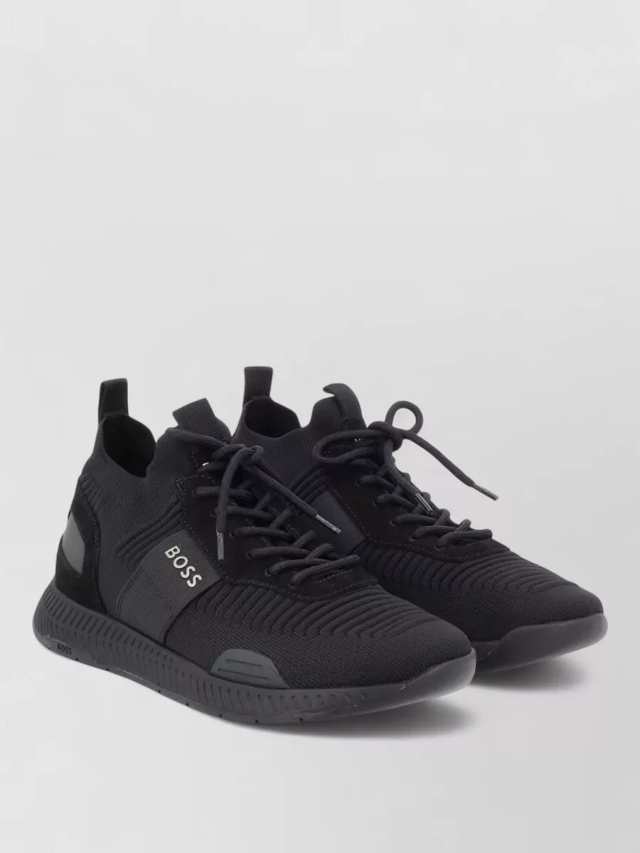 Boss Logo low-top sneakers — The black sock-fit hi-top sneaker mirrors the bomber’s modern padded vibe, keeps the outfit fully monochrome, and reinforces the athletic, city-ready silhouette with a slightly tech edge.