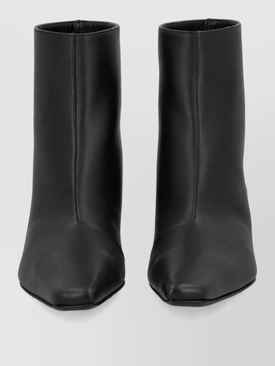 Loulou Studio Leather boots — The sleek black square-toe ankle boots sit cleanly under the wide-leg trouser and echo the coat’s minimalist, architectural mood.
