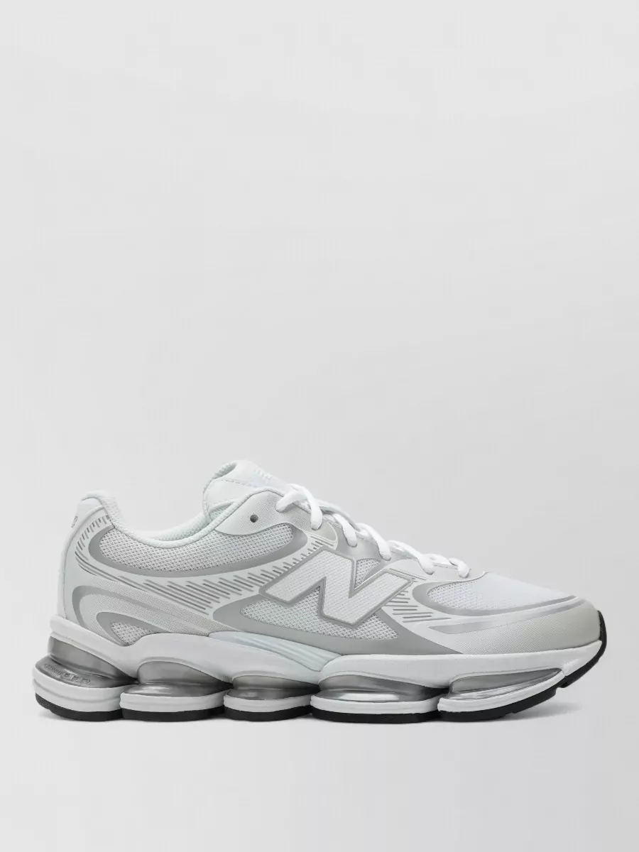 New Balance Low-top sneakers — The chunky all-white New Balance runner echoes the hoodie’s crisp white and adds a modern, athletic base that feels right for spring-summer city movement.