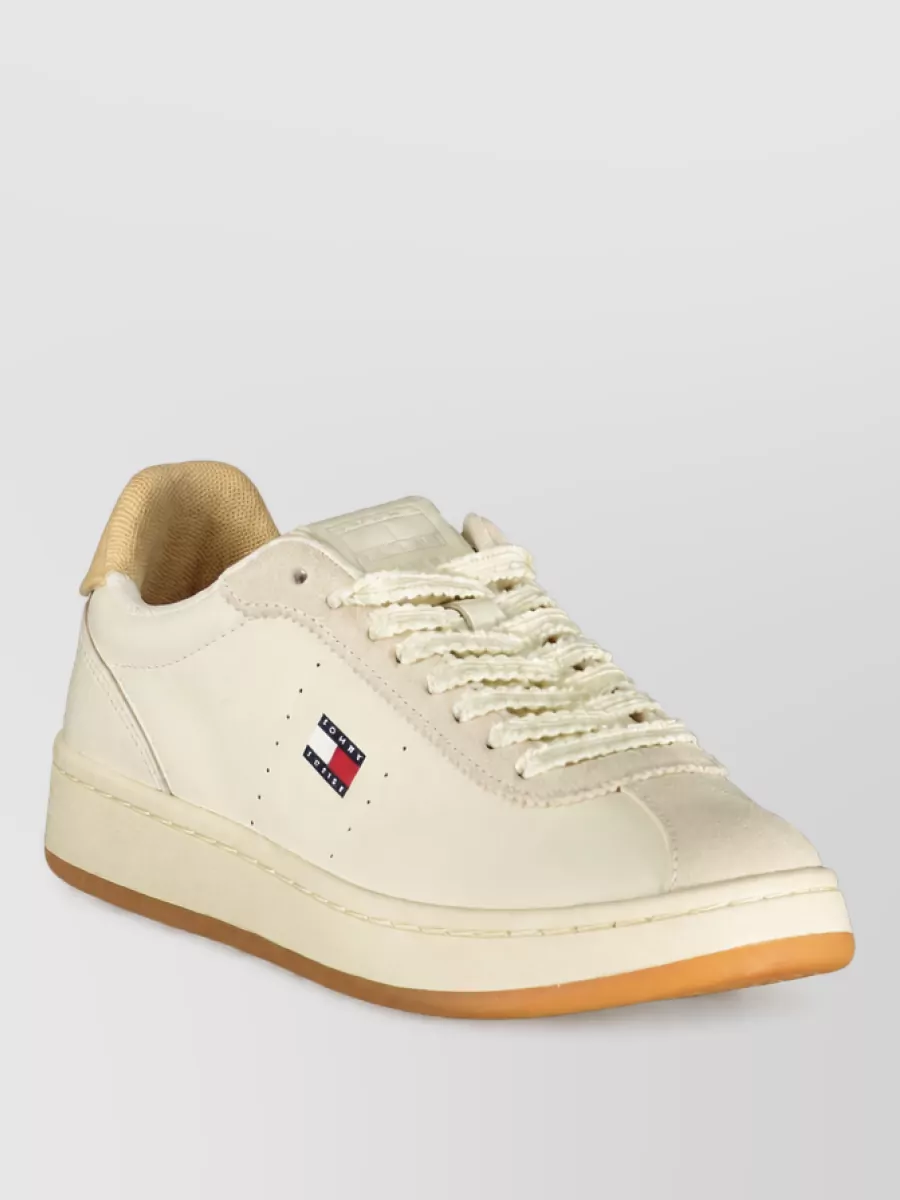 Tommy Hilfiger Leather lace-up sneakers — The cream sneakers with sand beige and a light gum sole sit quietly under the outfit, tying into the beige shorts and keeping the palette soft and minimal while matching the preppy-sporty tone.