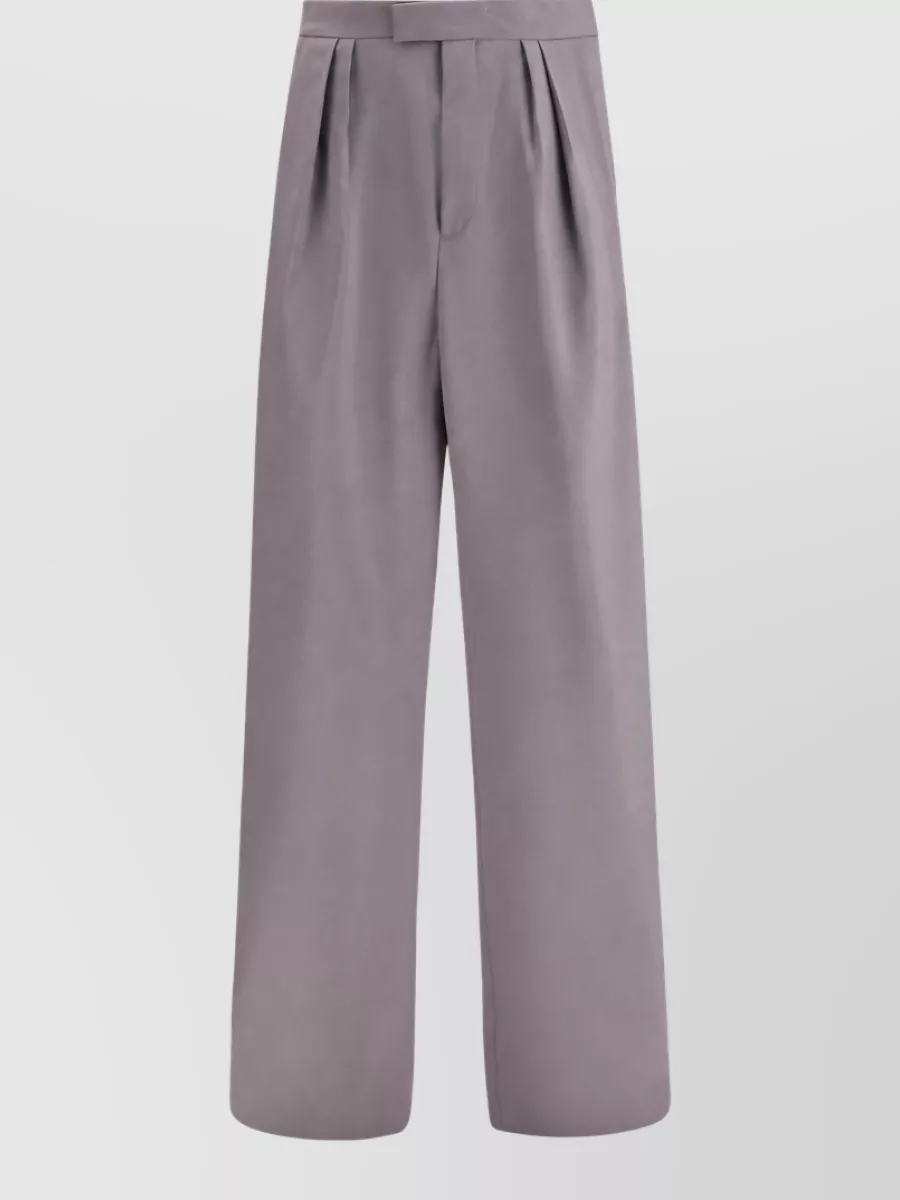 Dries Van Noten Wide-leg trousers — The dove grey high-waisted wide-leg trouser keeps the formality at blazer level while softening the all-black with a minimalist, tailored contrast that feels very Dries and summer-appropriate.