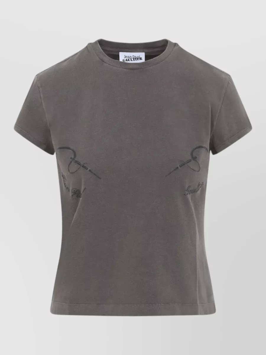 Jean Paul Gaultier Slim-fit cotton jersey t-shirt — The cropped washed-charcoal Gaultier tee mirrors the streetwear edge and cut-out drama of the deconstructed trousers while keeping proportions short over the high rise and the palette within cool greys and blacks.
