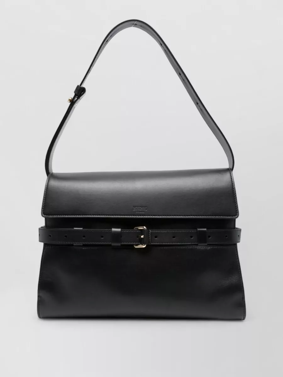 Moschino Leather shoulder bag — The structured black Moschino shoulder bag keeps the outfit in-brand and tailored, its minimal gold hardware quietly complementing the daisy centers without competing with the print.