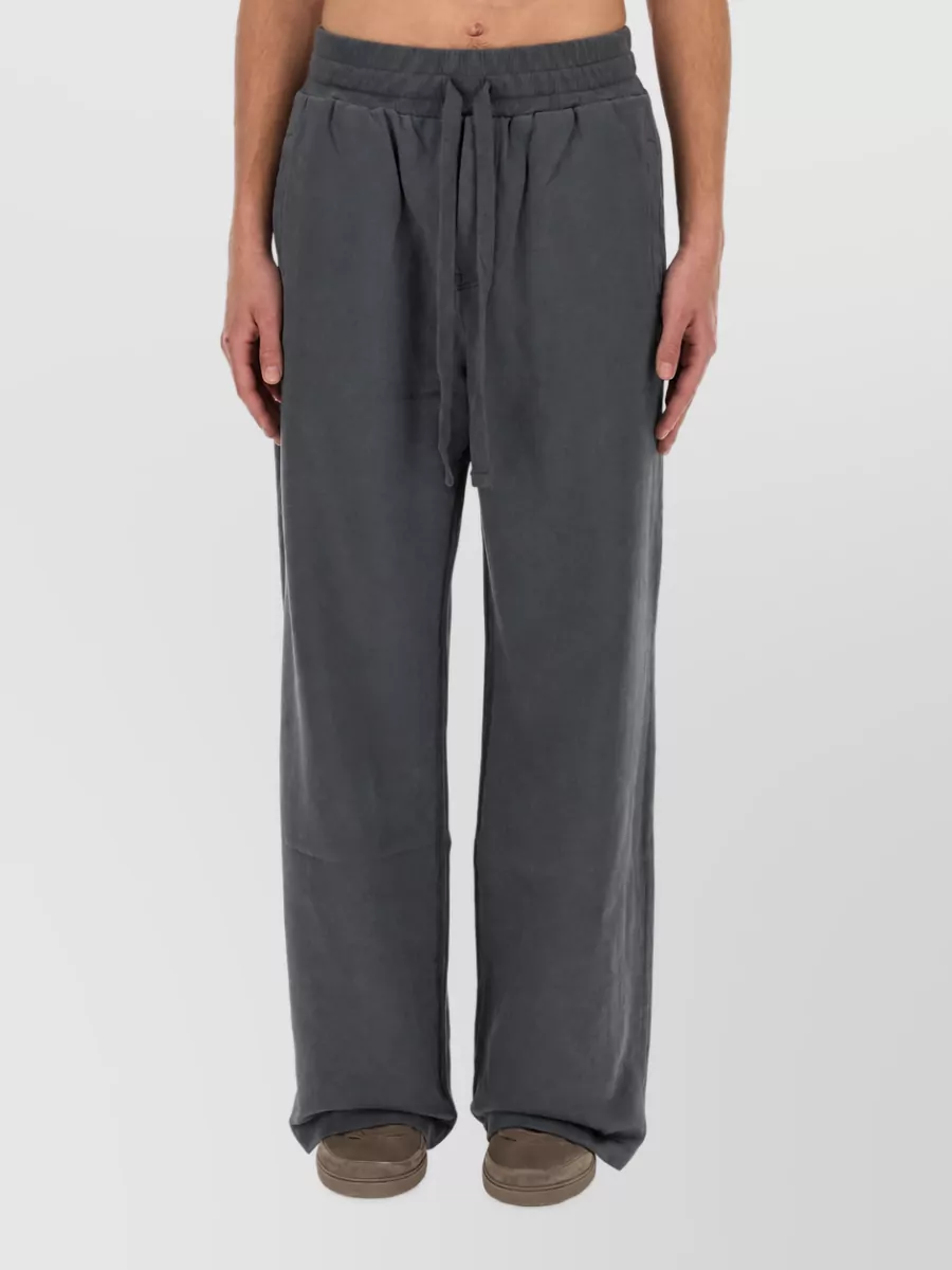 Dolce&Gabbana Cotton loose-fit jogging pants — The washed charcoal wide-leg pant mirrors the hoodie’s faded tone and relaxed volume, creating a cohesive, loungy street set that feels intentional rather than mismatched.