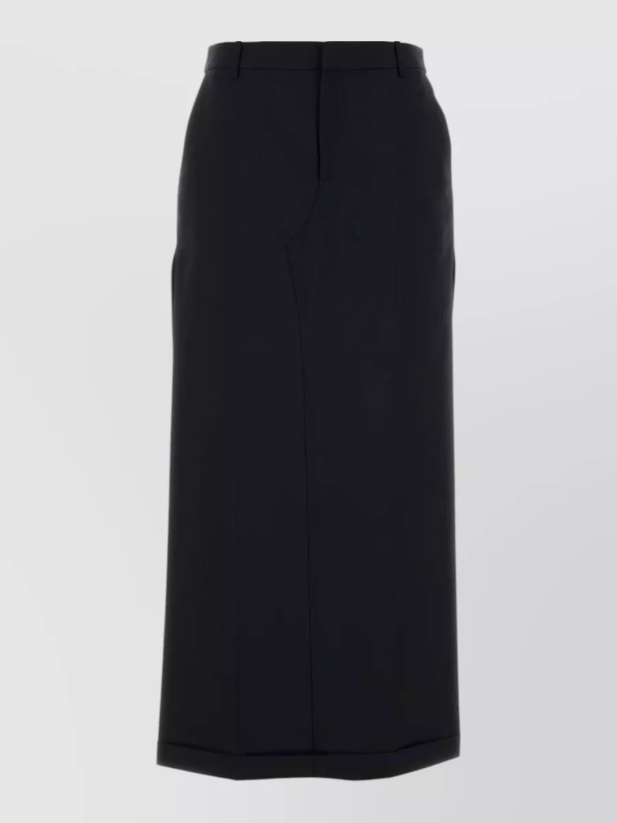 Alexander Wang Wool straight skirt — The straight black midi skirt sharpens the ribbed mock-neck into a minimalist, quiet-luxury column that suits the season and formality better than the sportier or overtly street minis and track pants.