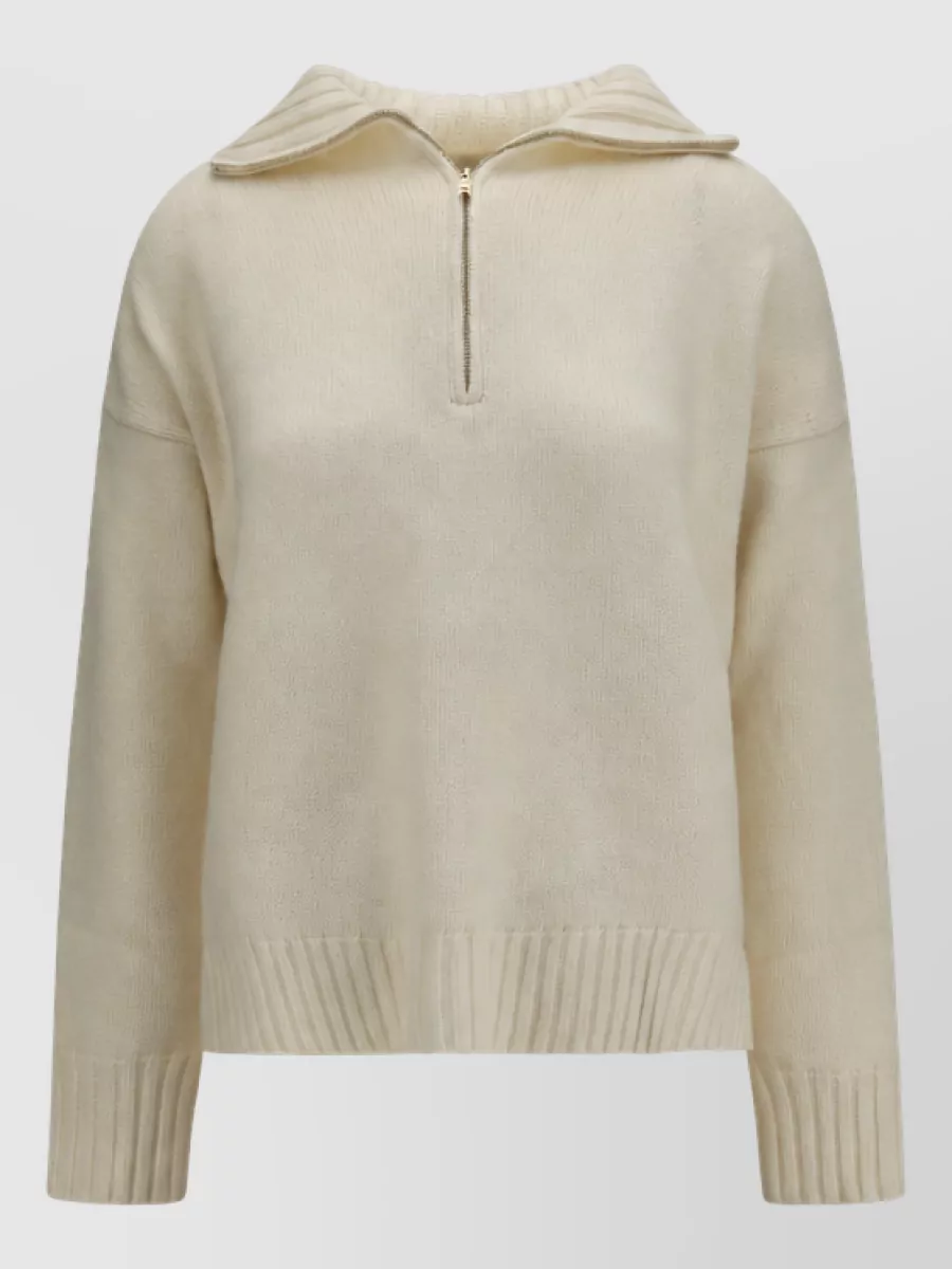 Max Mara Cashmere sweater — The ivory half-zip keeps the same relaxed, luxe knit language as the camel pants while adding a soft contrast that brightens the tonal palette and balances the wide-leg silhouette.