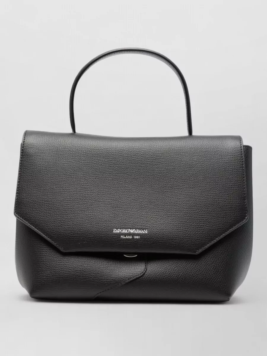 Emporio Armani Pebbled leather shoulder bag — The black structured Emporio Armani top-handle bag reinforces the city-ready, tailored mood and ties seamlessly into the black footwear without distracting from the navy suiting.