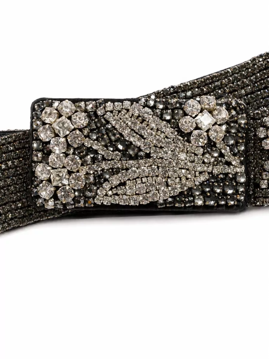 Miu Miu Silk belt — The Miu Miu crystal waist belt cinches the sheer mini and doubles down on the sparkle story, creating a strong, leggy evening silhouette in the same black-silver register.