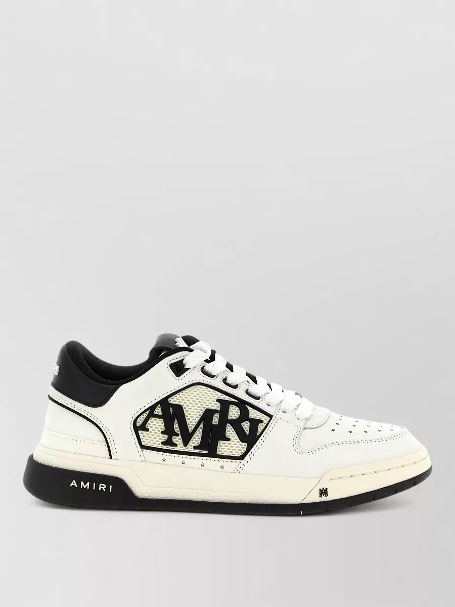 Amiri Leather classic low sneakers — The black-and-off-white Amiri court sneakers echo the pant’s stripes and logo for a head-to-toe set feel while maintaining the same elevated streetwear tier and seasonality.