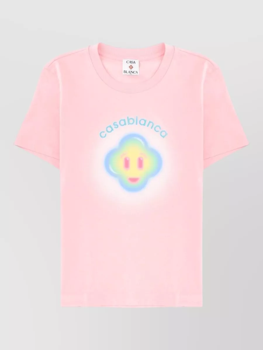 Casablanca Airbrush smiley cotton t-shirt — The cropped pastel striped Casablanca polo mirrors the apricot short’s soft tones while defining the waist against the relaxed elastic, keeping the set playful, preppy and balanced for warm days.