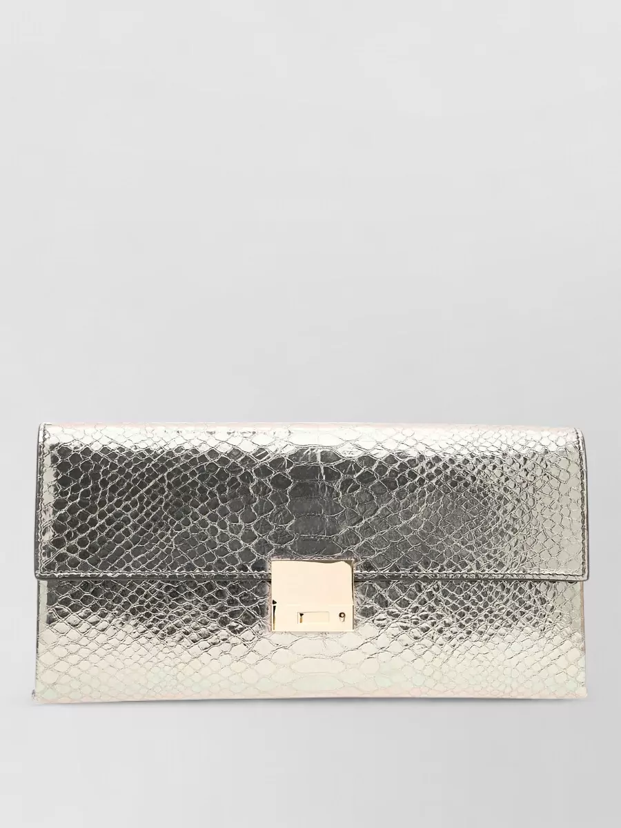 Tom Ford Na leather clutch bag — Tom Ford’s metallic silver clutch sits in the same high-gloss tier as the Aquazzura heels, echoing their silver without overpowering the softer champagne tone of the dress.