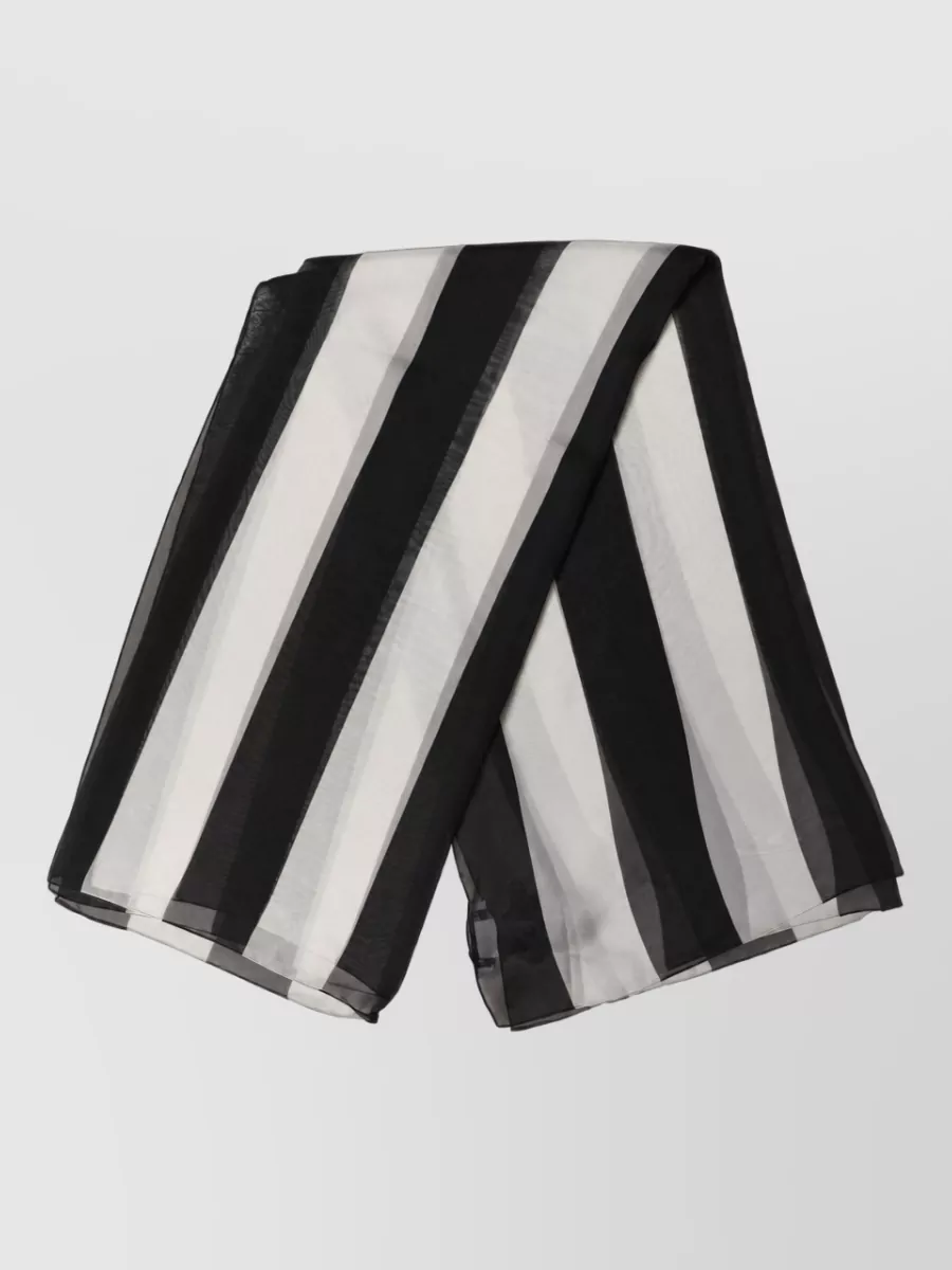 Dolce&Gabbana Silk striped square scarf — The sheer black-grey-white striped scarf adds a subtle vertical accent that harmonizes with the monochrome palette and long tailored lines without disrupting the minimalist mood.