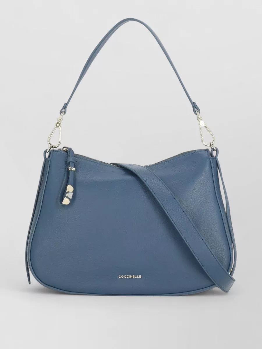 Coccinelle Leather shoulder bag — The Coccinelle dusty steel-blue hobo harmonises with the tee’s blue tones, keeps the price tier aligned, and its softly structured shape suits the relaxed, polished feel of the outfit.