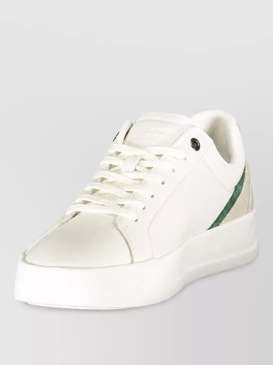 Tommy Hilfiger Polyester athletic sneakers — The Tommy Hilfiger off white sneaker with subtle green accent keeps things fresh and sporty, quietly brightens the darker top-and-short combination, and matches the modern preppy energy of the outfit.