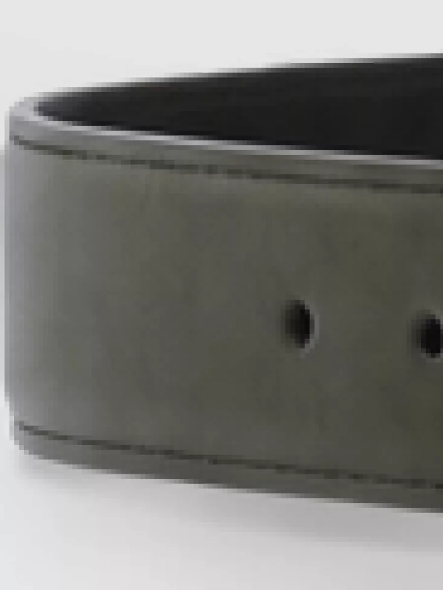 Saint Laurent Calfskin belt — The slim black Dolce&Gabbana belt quietly grounds the waist against the pale denim and beige tee, sharpening the silhouette while staying minimal and seasonless.