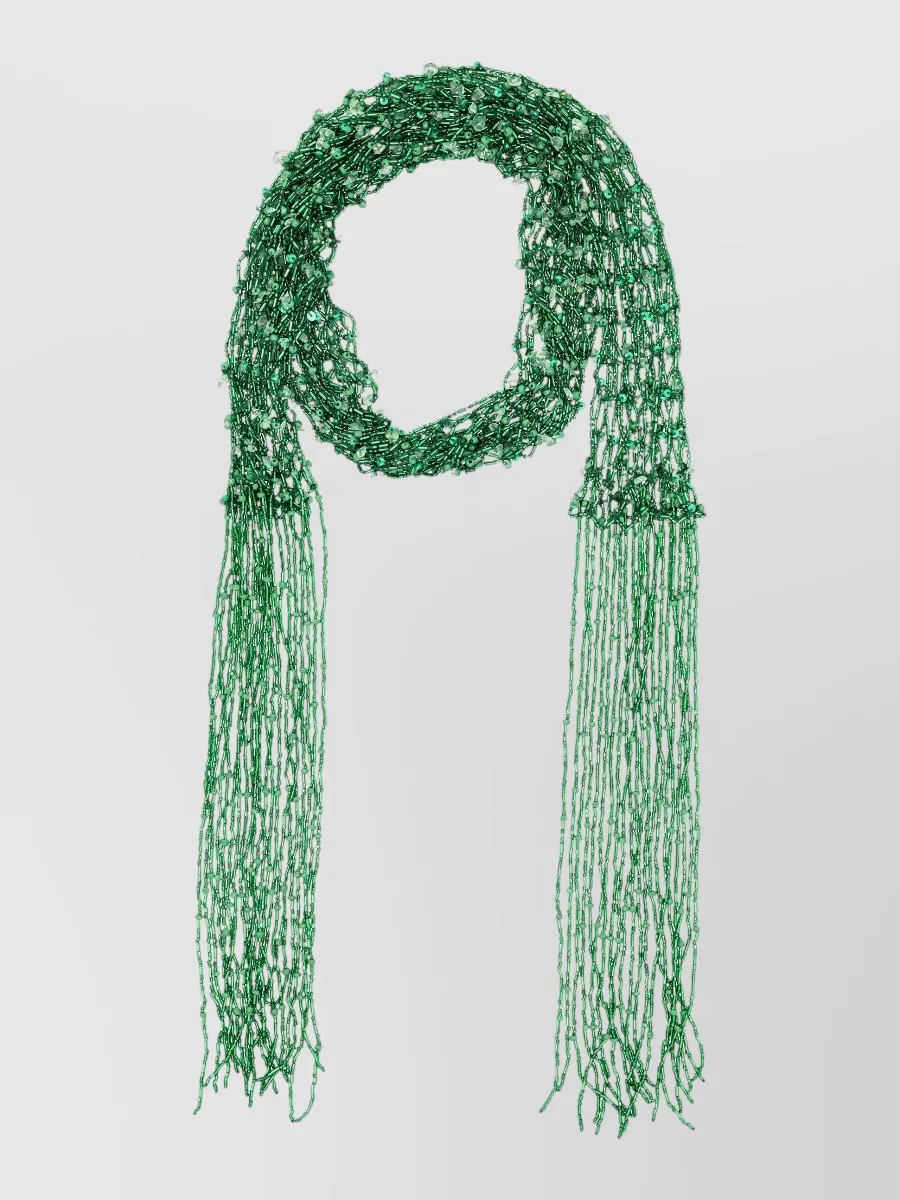 Dries Van Noten Beaded scarf necklace — The long emerald open‑knit scarf behaves like jewelry, dropping a vertical line of contrasting green that flatters the high waist and ties into the bag’s jewel‑tone mood without crowding the print.
