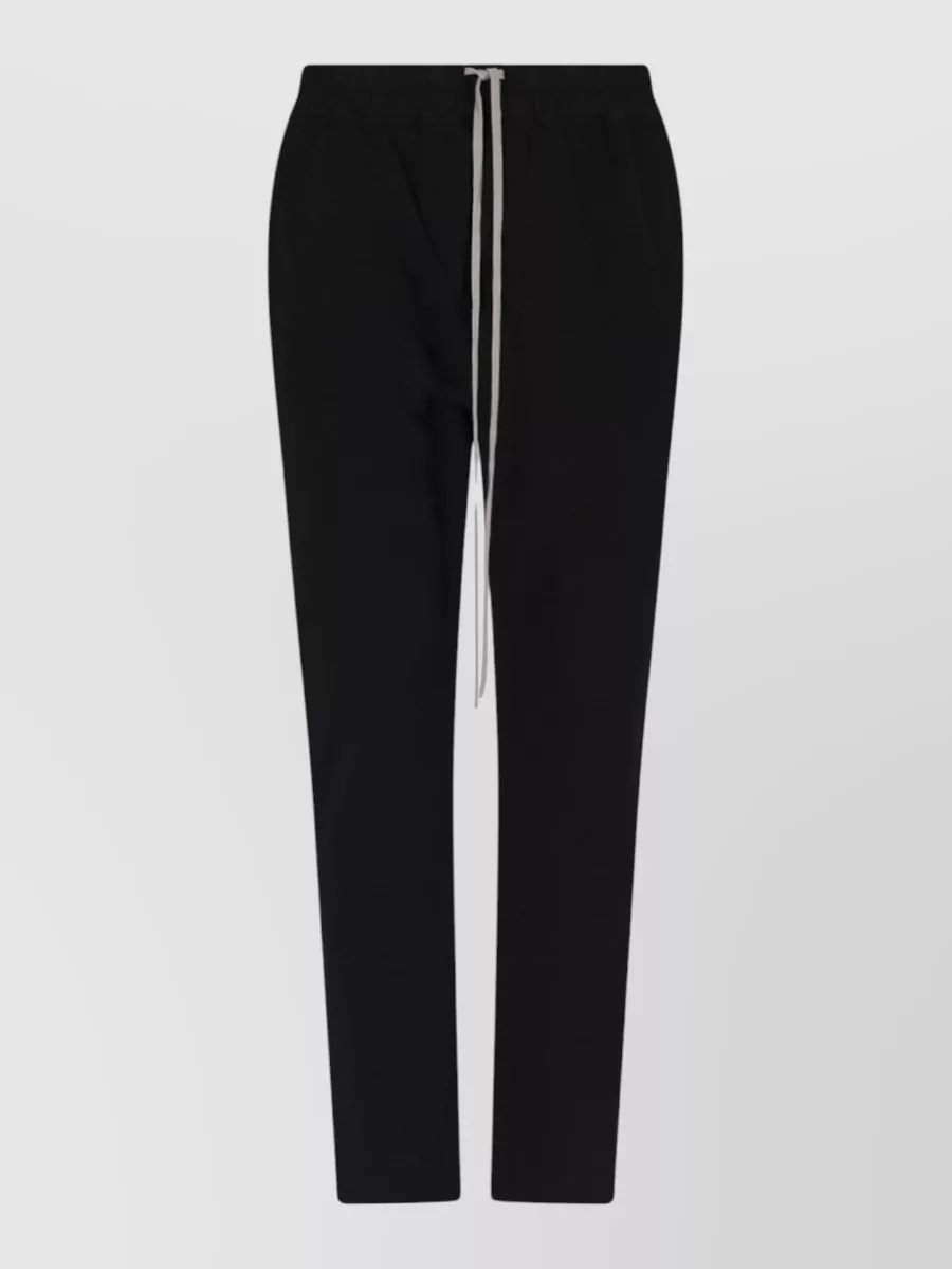 Rick Owens Drkshdw Cotton straight leg drawstring loose trousers — The tapered DRKSHDW drawstring pant keeps everything in the Rick universe, echoing the tee’s elongated, grungy mood while streamlining the silhouette over high-top sneakers.