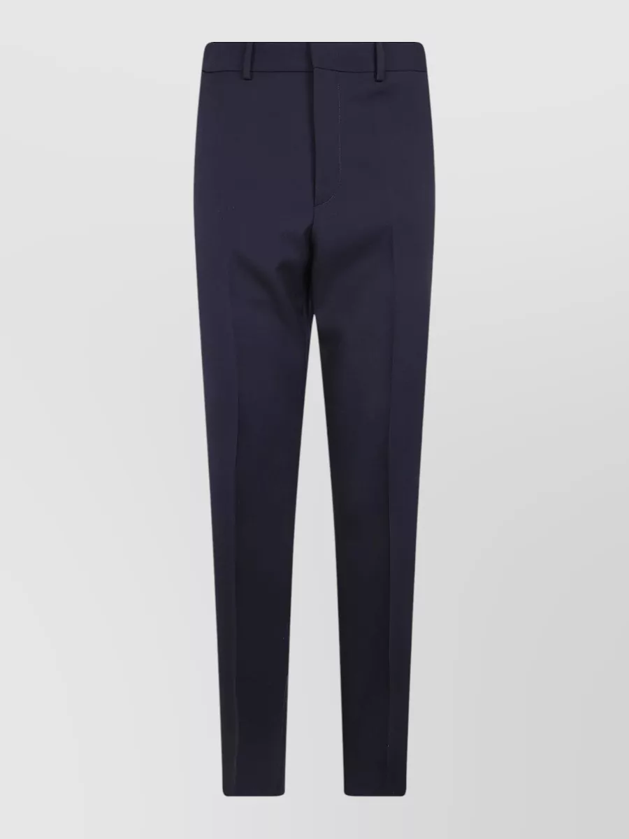 Jil Sander Wool tailored trousers — The Jil Sander midnight navy tailored trouser offers a clean, slim line and true quiet-luxury refinement that pairs tonally with the navy DB jacket without shouting logos or pattern.