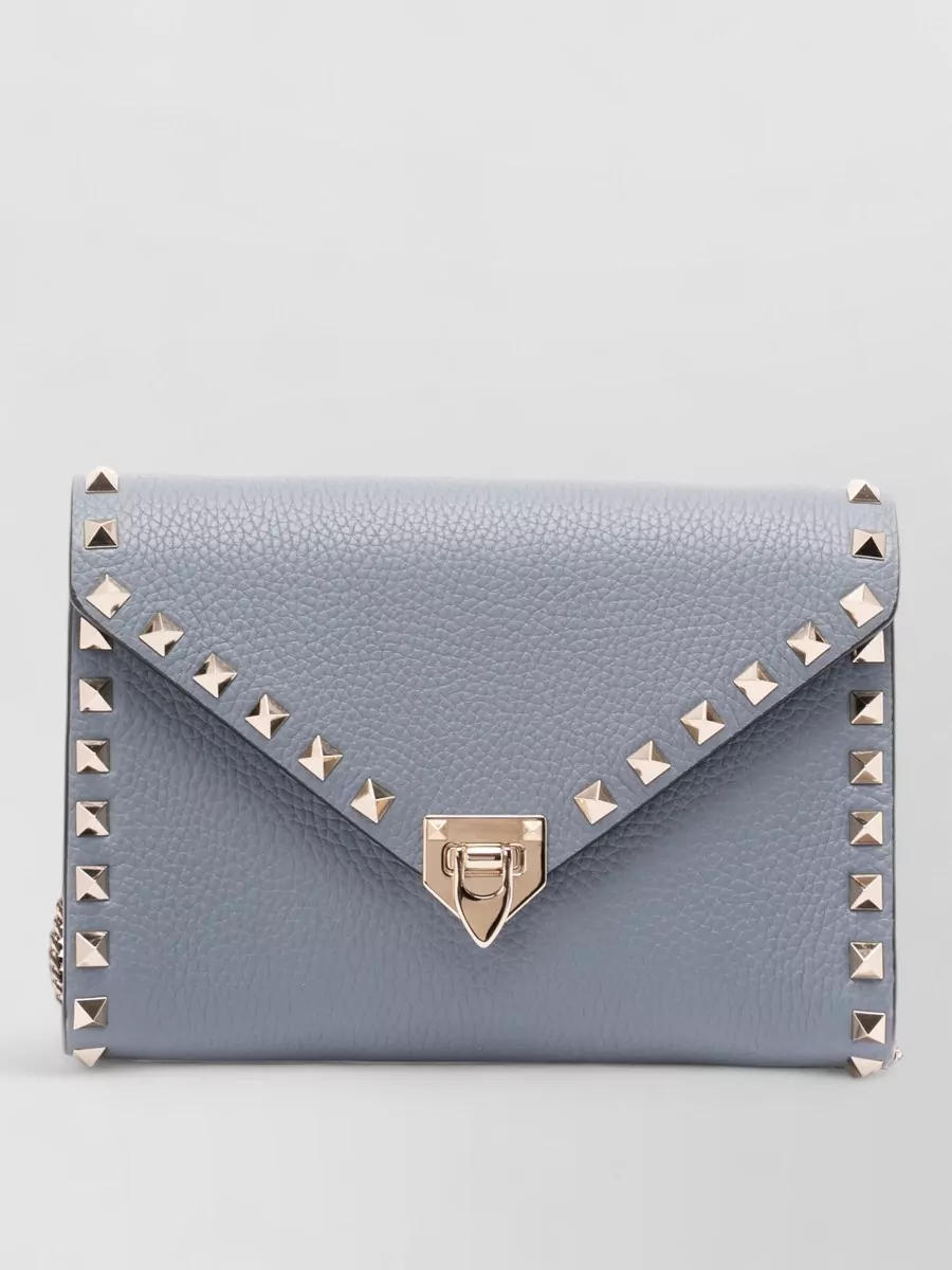 Valentino Leather crossbody bag — The Valentino slate blue-grey studded cross-body hits the same refined, slightly subversive mood as Dries and Rick, adding a compact metallic accent that harmonizes with the cool palette.
