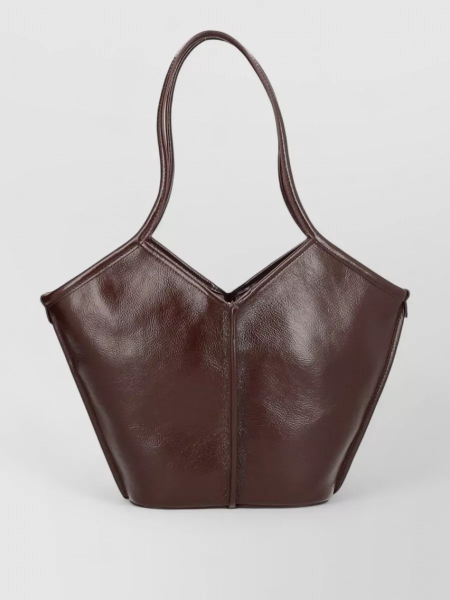 Hereu Leather tote bag — The dark chocolate sculpted tote adds a richer neutral that grounds the creamy denim and camel knit while keeping the overall mood minimalist and quietly luxurious.