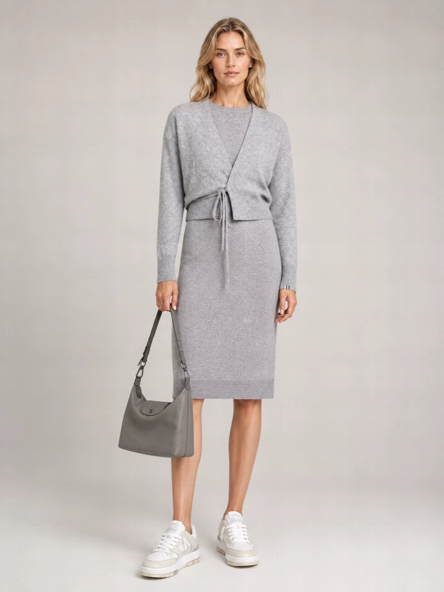I’m opting for the dress route so the cropped wrap cardigan can act as a structured top layer over a single, clean grey column rather than fighting with a separate waistband. The Max Mara knit dress and Extreme Cashmere cardigan read like a tonal set, with the pale layered sneakers and grey bag keeping everything soft, practical and quietly polished for day. It is an easy, monochrome knit story that feels intentional from coffee to late train home.