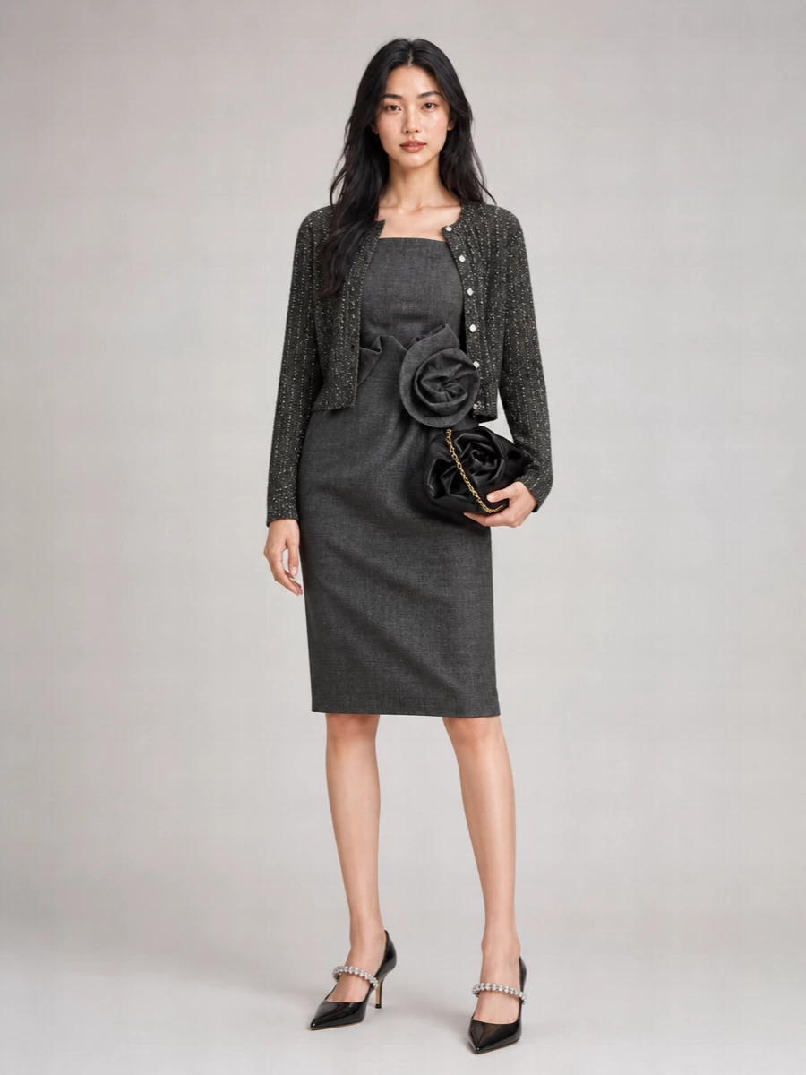 I am styling the Dior sequinned cardigan as refined outerwear over a single anchor dress, and the Magda Butrym charcoal rose sheath is the most coherent choice. Their shared charcoal palette, couture structure and quiet shimmer create a romantic, boardroom-to-cocktail narrative, simply finished with crystal-strapped Jimmy Choos and a sculpted Burberry clutch. The result is a long, lean winter evening silhouette that feels sharp, feminine and genuinely Dior-appropriate in tier and tone.