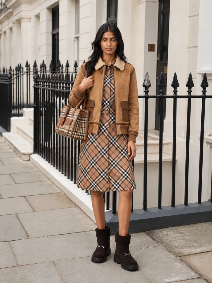 This is a polished heritage city ensemble built around camel and check, where the aviator jacket and Burberry shirt dress read as one cohesive story rather than separate statements. I chose the dress path to keep the lines long and uncluttered under the cropped bomber, letting the proportion feel modern and easy while the shearling boots and structured bag add winter weight and finish. The result is quietly confident, tactile and ideal for crisp days when you want warmth and refinement in equal measure.