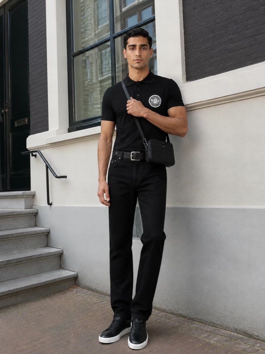 A monochrome Balmain base keeps this outfit sharp yet relaxed, with the straight-leg black trousers grounding the crest polo in clean lines. Black leather sneakers and a precise Prada belt underline the quiet, designer polish. Celine’s structured crossbody finishes the story with a compact, logo-textured hit that feels considered rather than flashy.