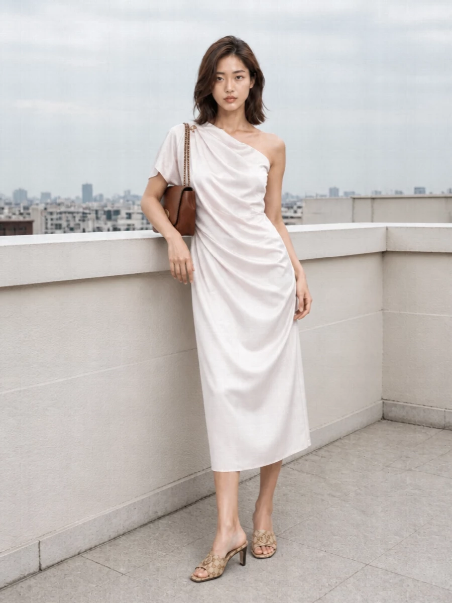The one-shoulder satin dress becomes the anchor here, its soft ivory and light gold tone echoing the Gucci mules for a seamless, tonal evening story. I chose the dress path over separates to keep the silhouette clean and elongated, letting the fringe detail and asymmetric neckline provide all the interest. The cognac shoulder bag grounds the light neutrals with a subtle hit of depth, keeping the mood quietly glamorous rather than high-drama.