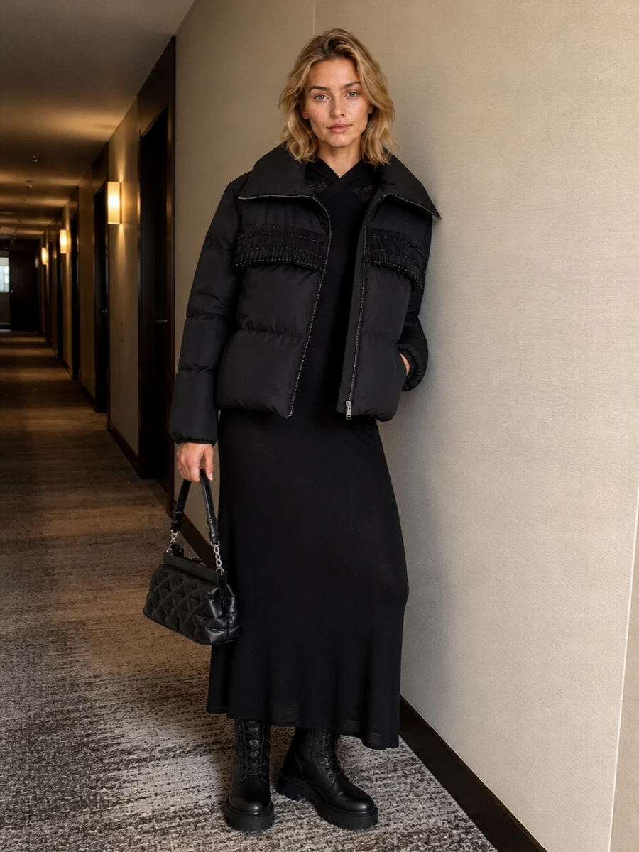 Here the Moncler fringe puffer becomes a sculptural shell over a sleek Fendi hooded knit dress, all in deep black so texture and line do the talking. Quilted Moncler lug boots and a softly structured Margiela frame bag keep the story padded and technical, but the overall effect is quietly polished enough for city dinners as much as cold-day errands. I chose the dress route over separates to avoid breaking the long line, letting the jacket’s shorter, cocooning volume and fringe detail sit cleanly against a single uninterrupted silhouette.