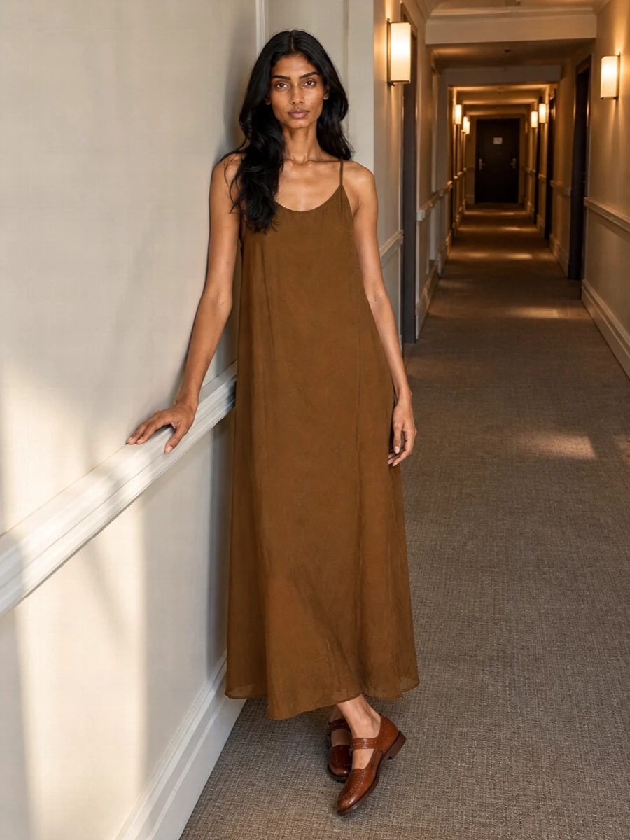 Leaning into the dress path keeps the story clean and uncomplicated, letting the caramel Uma Wang slip and woven cognac bag share the spotlight. The result is an easy, sun-warmed column of brown tones with subtle texture play rather than shouty detail. Hereu’s structured slingbacks finish it with just enough polish for city terraces or slow coastal evenings without breaking the relaxed, bohemian mood.