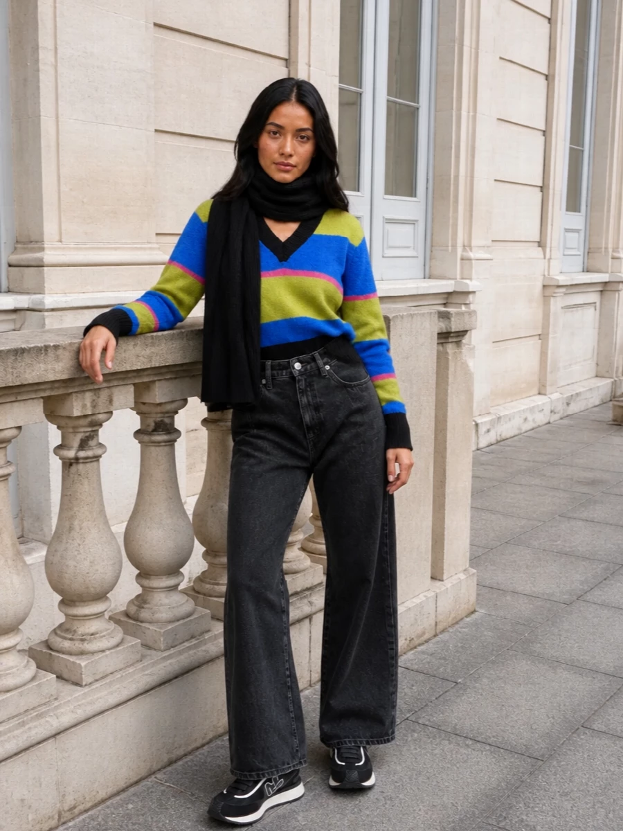 Bold stripes stay in the spotlight against washed-black wide-leg denim that relaxes the line without losing polish. Graphic monochrome runners and a ribbed black scarf keep things grounded, while the padded lime tote plays back to the knit’s acid tones for a confident, city-ready mix of streetwear and boho energy.