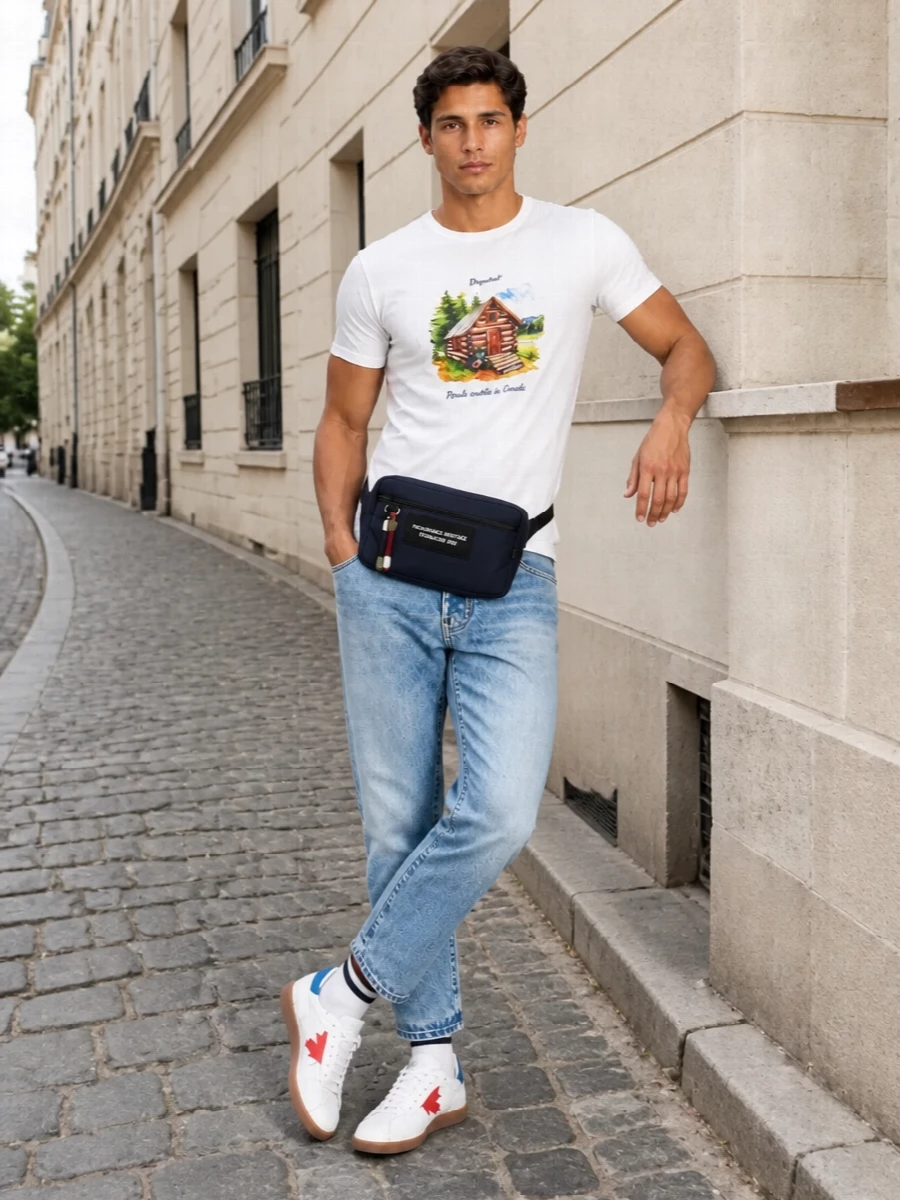 A clean graphic tee meets sun-faded denim for a relaxed, nostalgic take on city casual. Retro court-inspired sneakers and a compact navy belt bag keep it practical and street aware. Subtle striped socks finish the mix with a quiet preppy nod that matches the tee’s easy attitude.